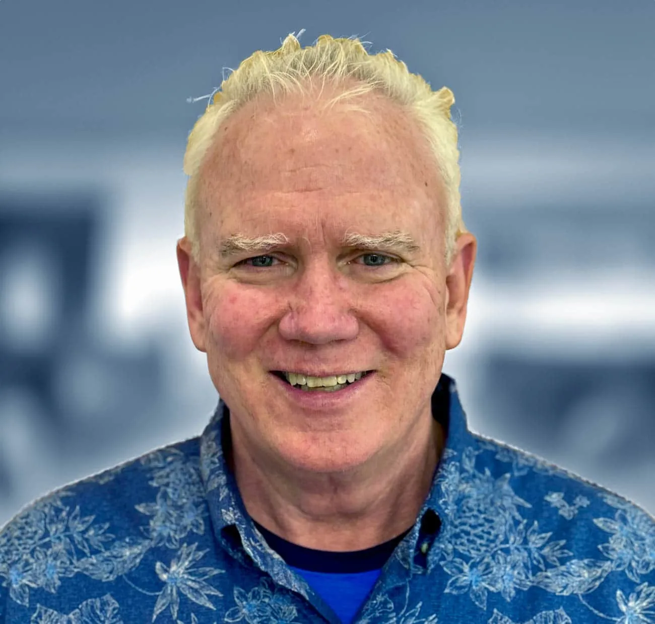 Dr. James Buechel, smiling orthodontist in a floral shirt, welcoming new patients at ARCH Orthodontics in Cape Cod.